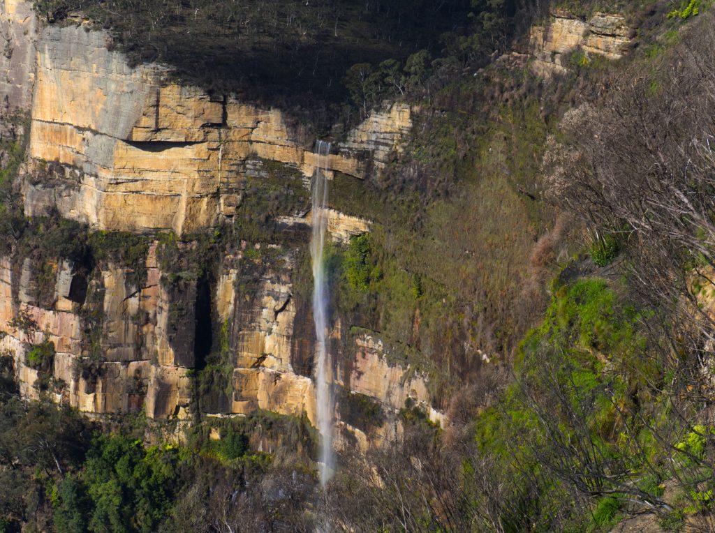 Bridal Veil Falls at Govetts Leap, Blackheath. Waterfall is flowing over the edge of a high cliff into the valley below.