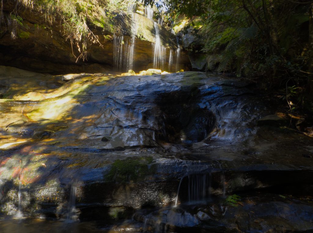 The first of the waterfalls along the Horseshoe Falls walking track is not signposted and no name has been identified. The water spills from the creek over a rock edge onto a larger rock below before falling into a small pool and continuing on into the gully