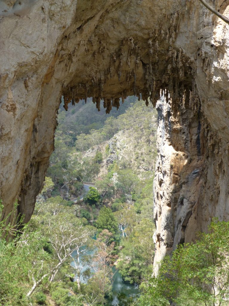 Carlottas Arch is a wall of rock eroded through the middle to form a massive archway, through which can be seen the Blue Lake