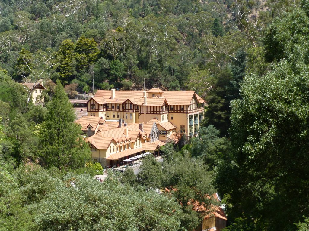 Jenolan Caves House, a grand Victorian style building, as viewed from the path between the car park and the caves entrance.