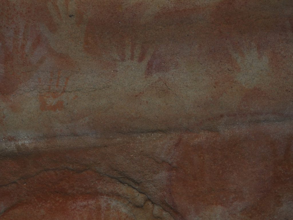 Aboriginal rock art at Red Hands Cave in Glenbrook. Art features ochre blown around hands to create outlines as well as handprints