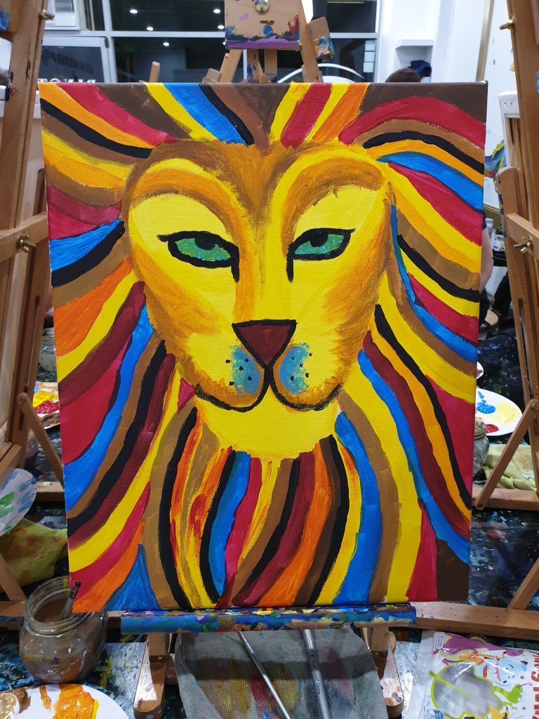 Colourful painting of a lion as completed in a class at Pinot & Picasso
