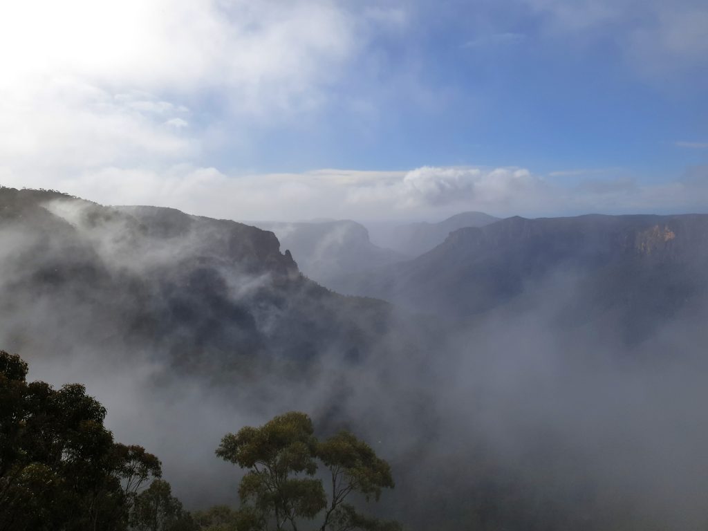 Mist rising out of the valley at Govetts Leap lookout in Blackheath after the weather has started to clear