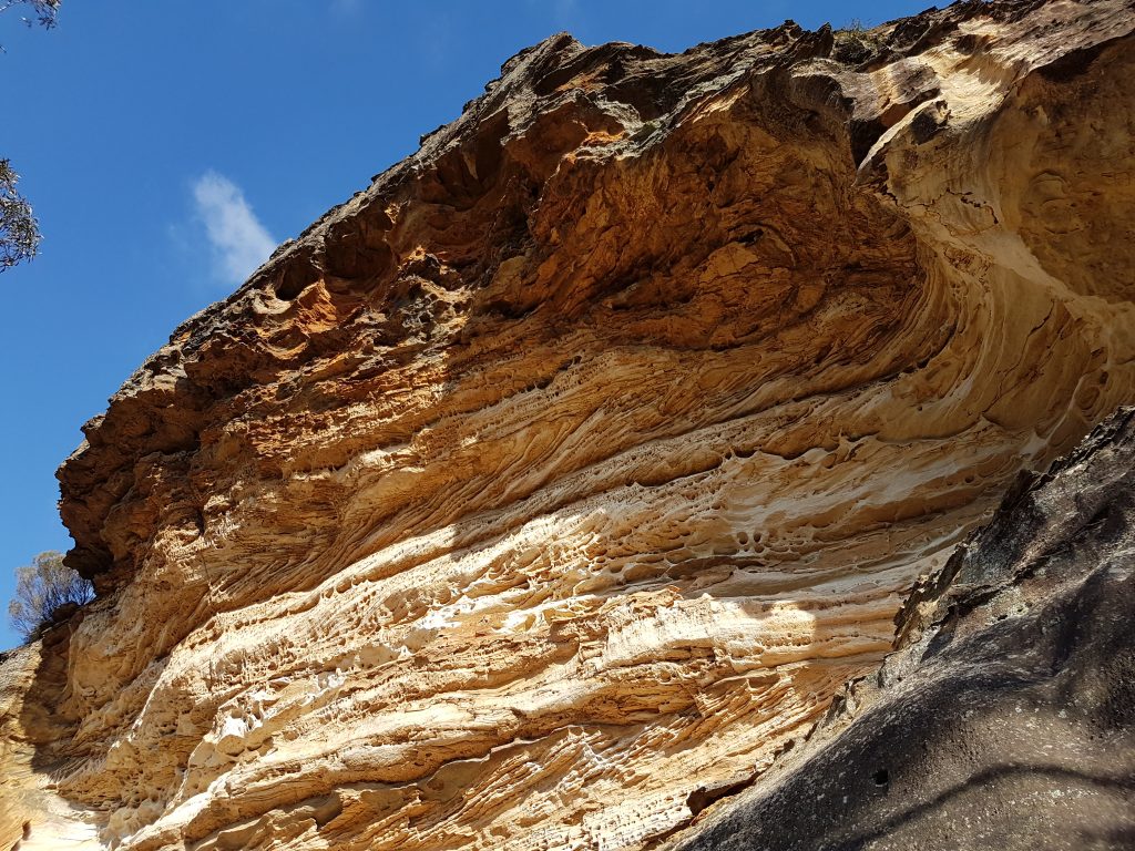 Image of a wave like rock formation called the wind eroded cave in Blackheath