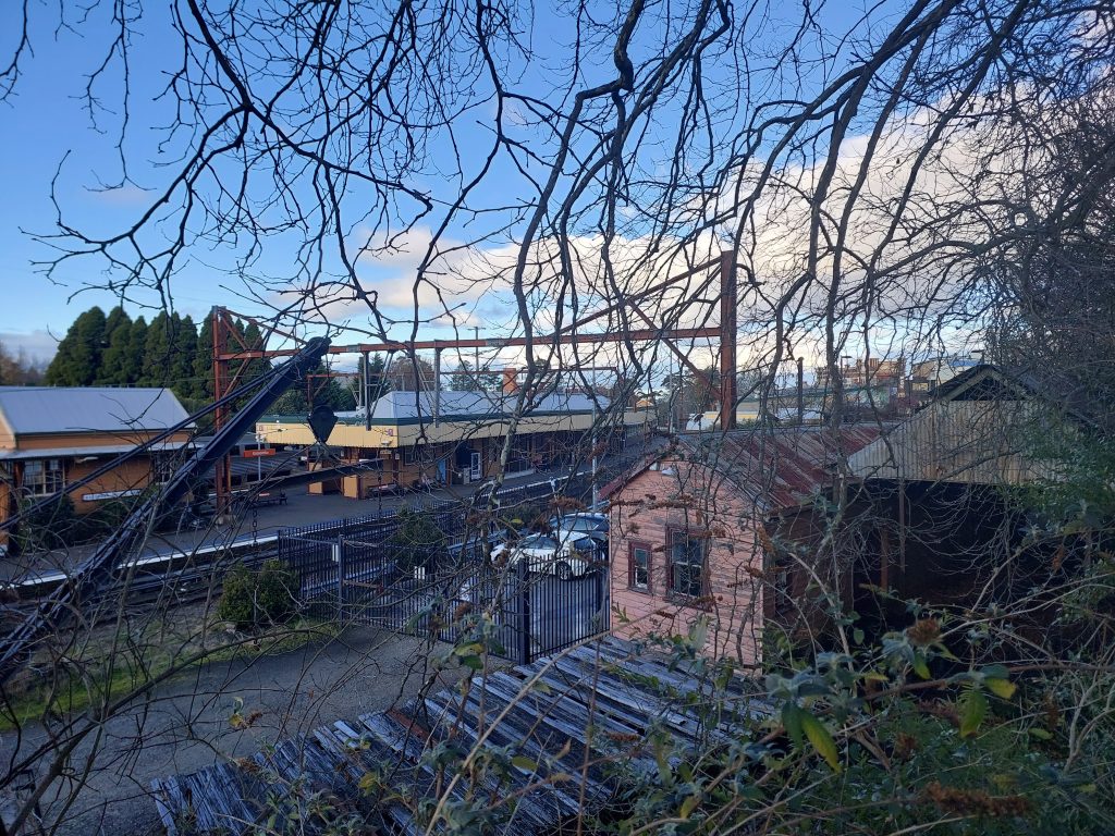 Looking down upon Katoomba station past the original wooden platform and brick station masters building