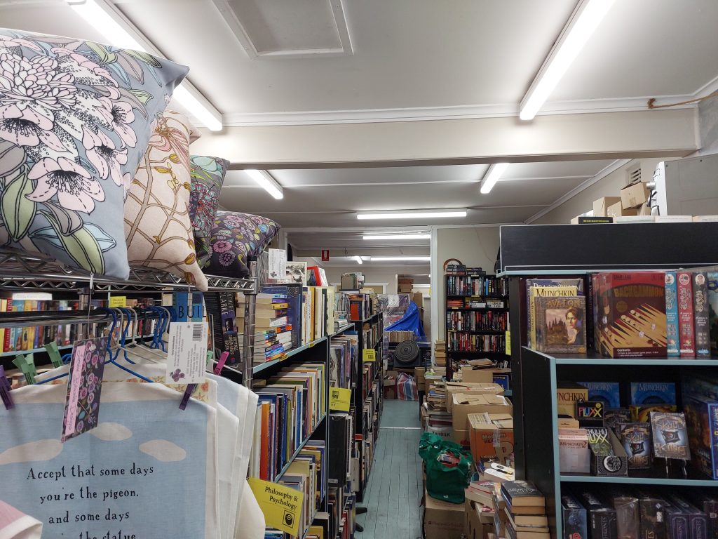 Image of the interior of Springwood book lounge, books are on shelves with a narrow aisle between