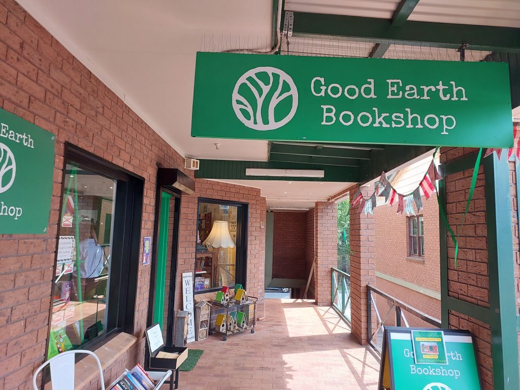 The external view of the Good Earth Bookshop in Wentworth Falls. A green sign hangs about the entrance. 