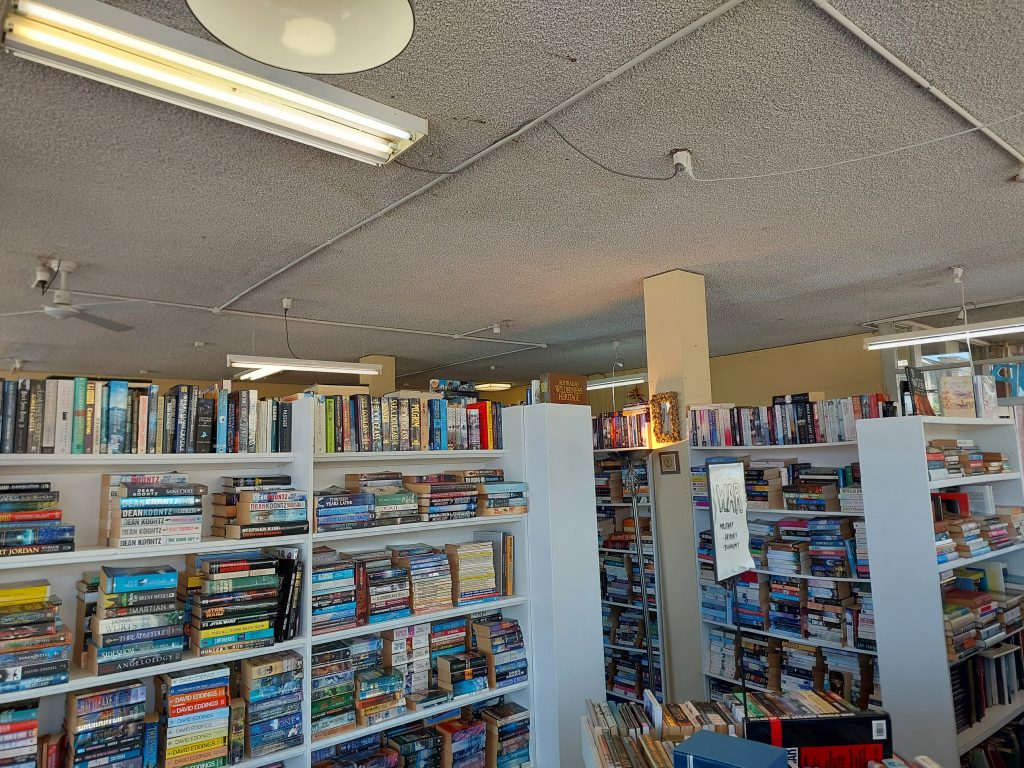 The interior of A Readers Heaven in Lithgow. White shelves are full of books.